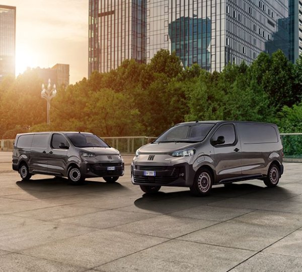 2 Scudo vans next to each other with a city building behind