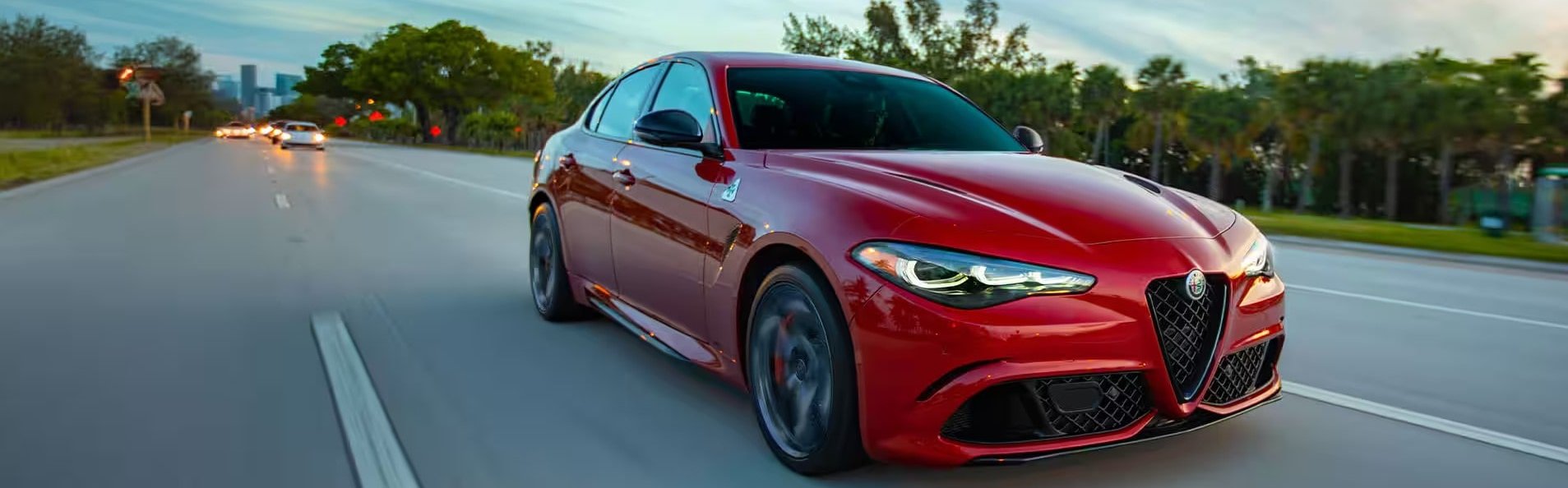 Alfa Romeo Quadrifoglio driving down a road