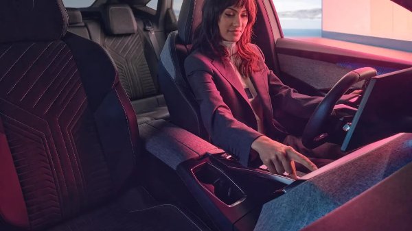 Woman sat in the drivers seat of the new Peugeot e-3008